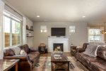 Gather in the spacious living room with a cozy gas fireplace and lots of natural light 